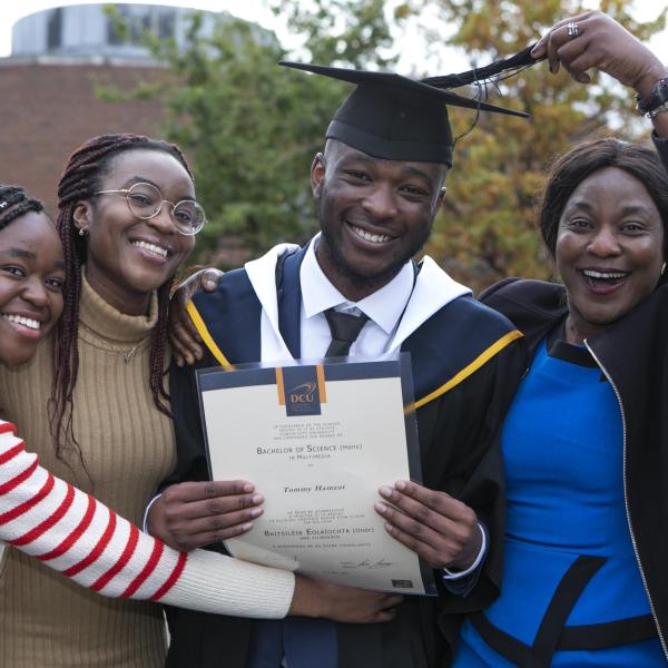 DCU Graduations - family celebrating student graduating