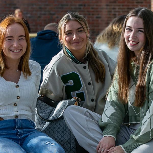 Shows three female students on DCU's Glasnevin campus