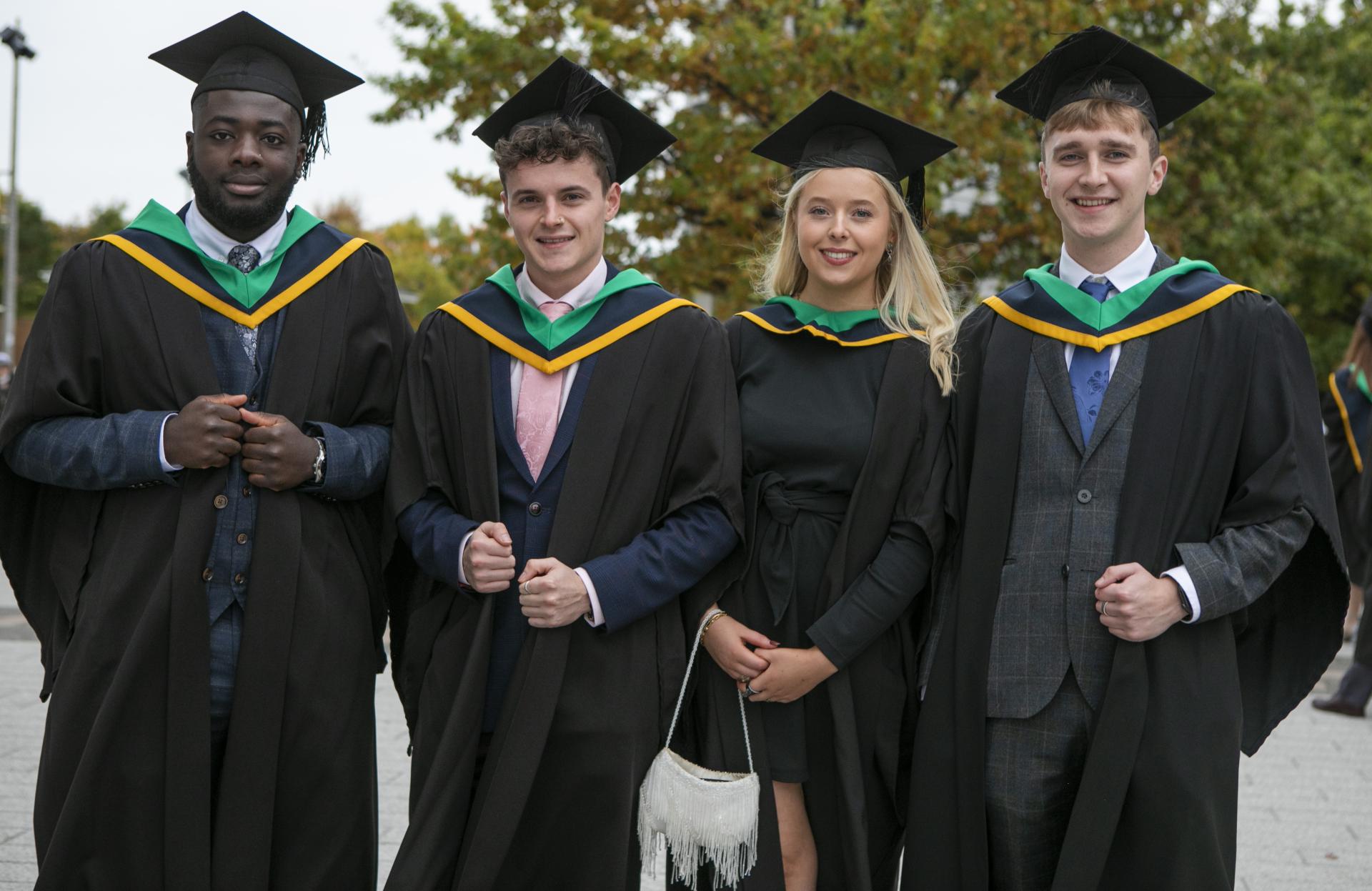 Shows four students after their graduation ceremony on DCU's Glasnevin campus