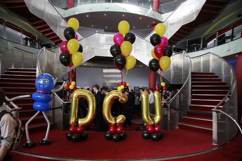 Balloons that spell out DCU at the 2018 Expo