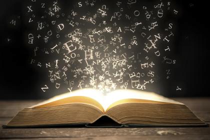 Open books with words flying into the air