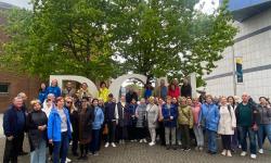 Ukrainian and Irish people in front of the DCU sign 