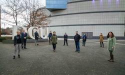 10 people standing in front of dcu sign