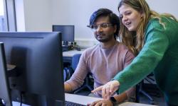 Students work on computer together