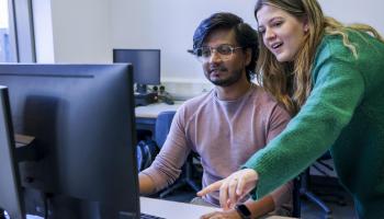 Students work on computer together