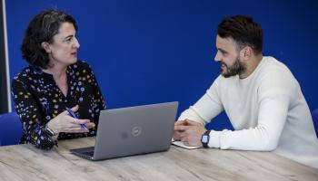 Shows an employer speaking with a DCU student
