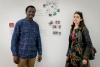 Photo of two participants beside their artwork