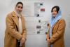 Photo of two participants beside their artwork