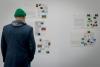 man looking at artwork