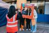 Three Prospective students pose with an Instagram cut-out frame promoting the Open Day, as a student helper takes a photo.