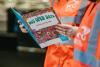 A DCU Student Helper reading the November Open Day brochure.