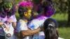 Student pictured with holi powdered colours on face