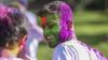 Student pictured with holi powdered colours on face