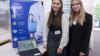 Students pose for a picture beside their project