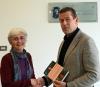 Gini McNulty-Mauchly presenting a commemorative book on JKay McNulty to Andrw MCCarren Head of School of Computing.