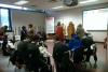 Group of people sitting in chairs at the age action conference