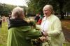 two women chatting and shaking hands in a parc