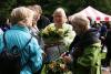 women talking, one is holding flowers