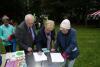 people writing on some paper in the parc