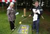 an elderly couple plays a game with some rubber ducks