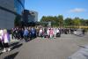 a big group of people walking across dcu campus