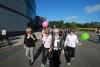 women walking across campus with some balloons