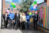 a group of people walking across campus with balloons