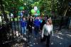 a group of people walking across campus with balloons