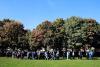 a group of people walking across campus with balloons