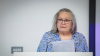 a woman speaks from a lectern