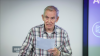 A man speaks from a lectern