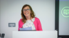 a woman speaks from a lectern