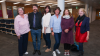 Six people standing in a line facing the camera