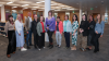 Twelve people standing in a line facing the camera