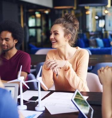 Young next gen woman leads team meeting in family firm