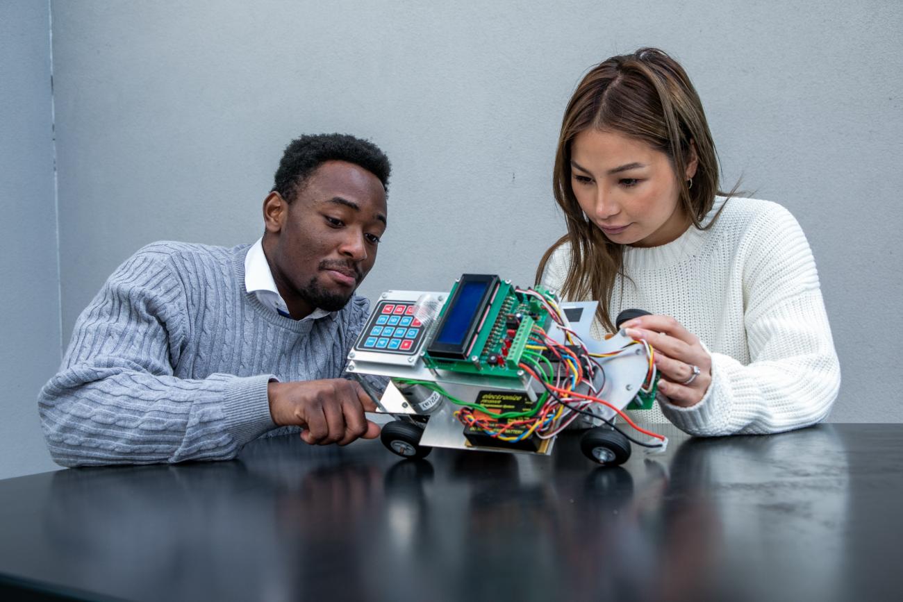 Students looking at electrical build