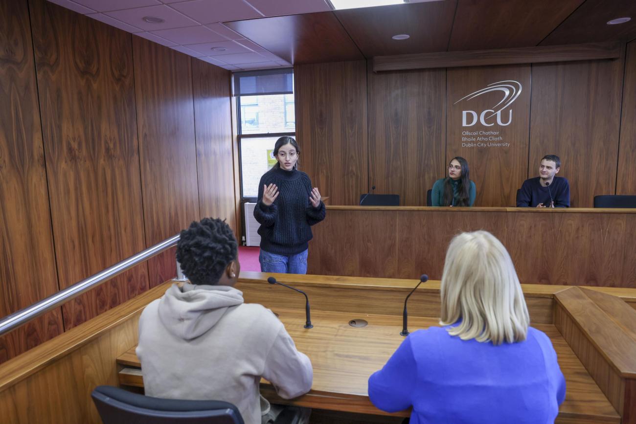 Students presenting in a court room environment