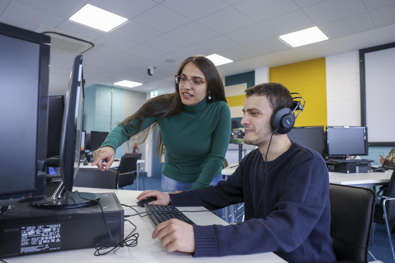 Students talking about the content displayed a screen
