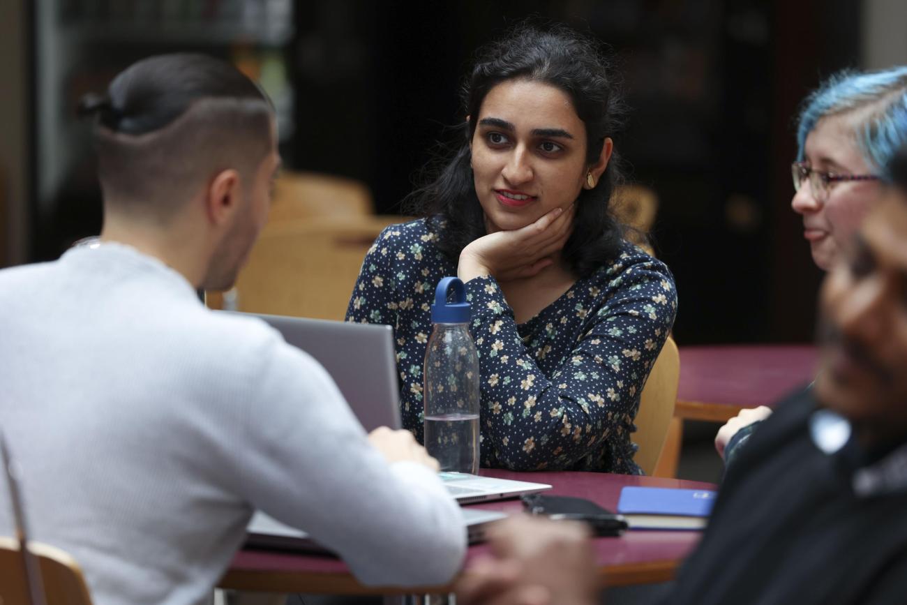 Students talking around a table