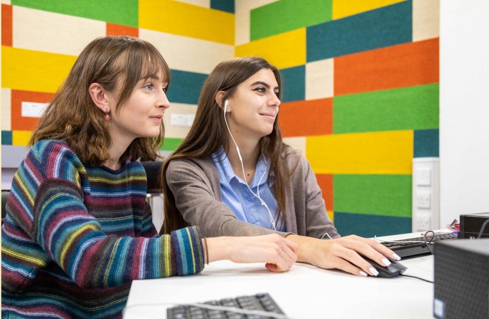 This image shows two female students working on a computer