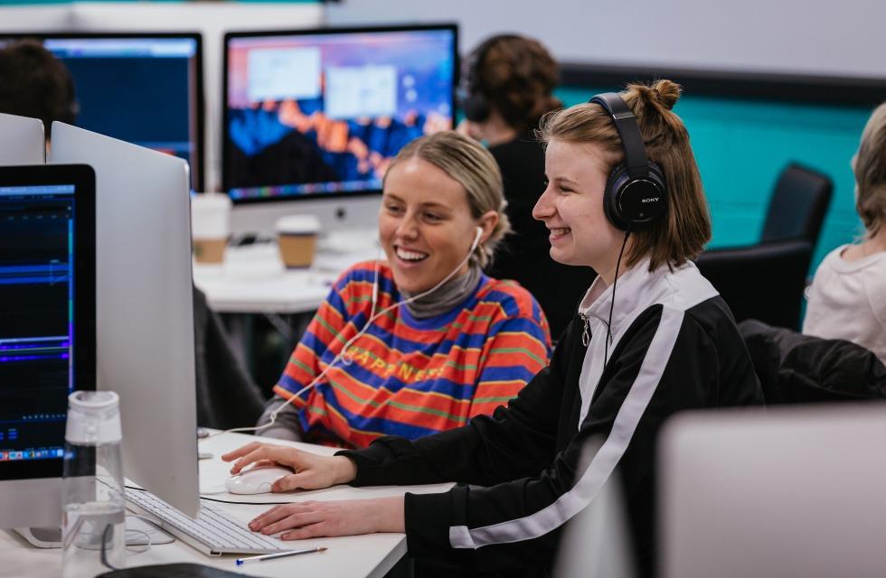 This photo shows to female students working on computer together