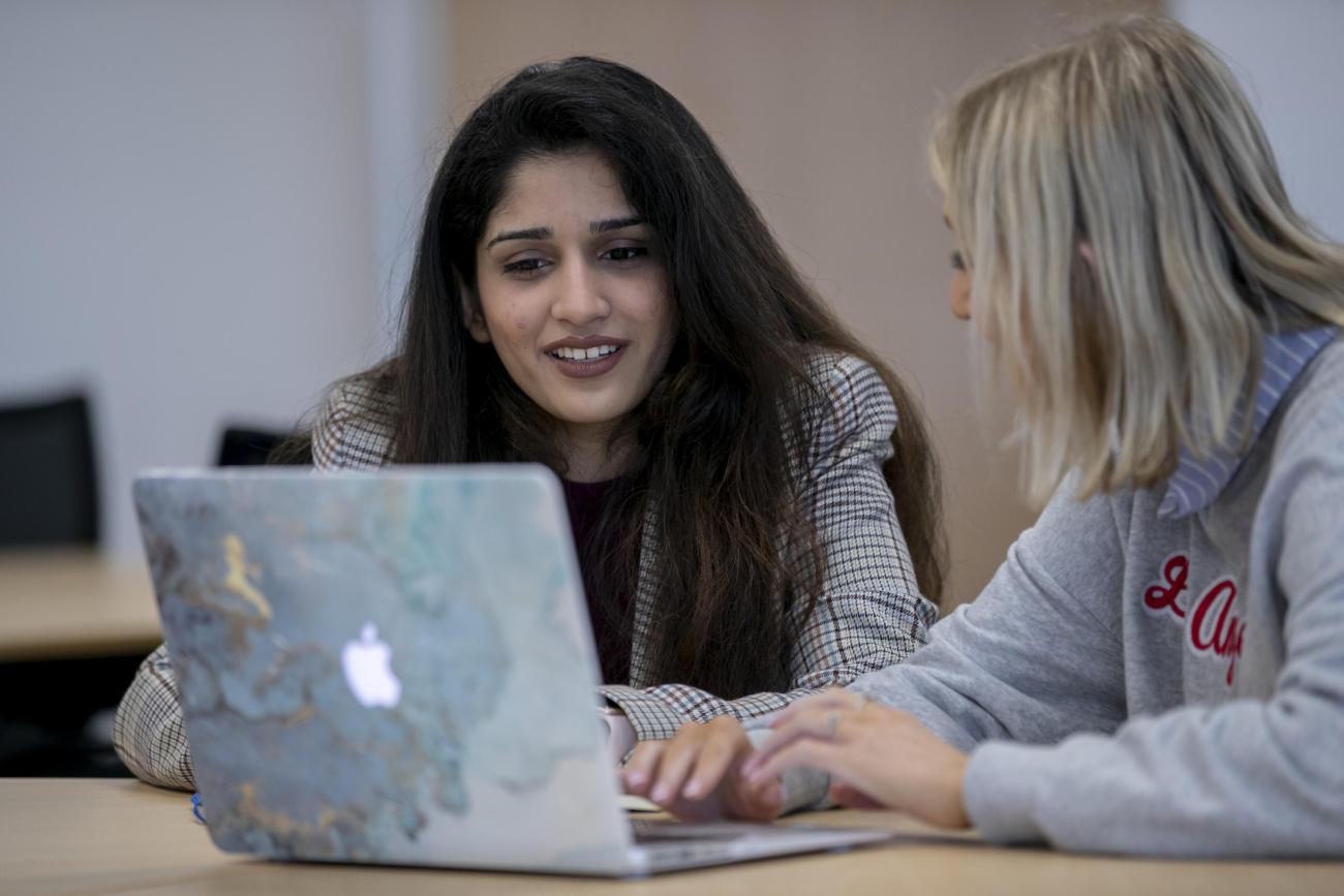 Shows two students chatting