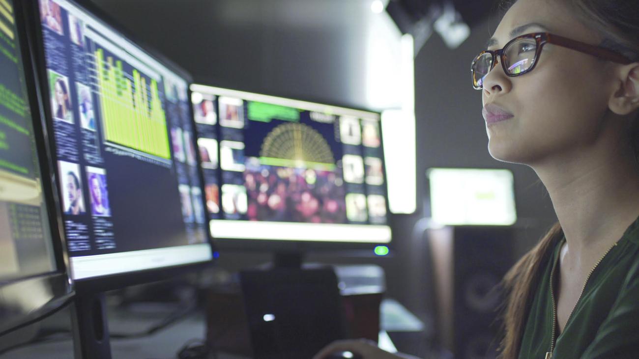 Woman looking at monitors