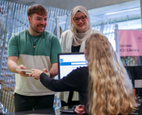 student returning books to library staff at issuedesk