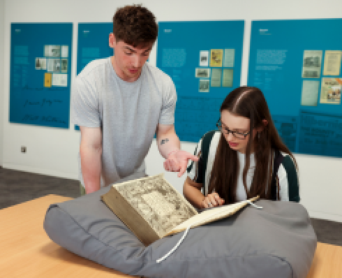 students consulting material in the Special Collections department