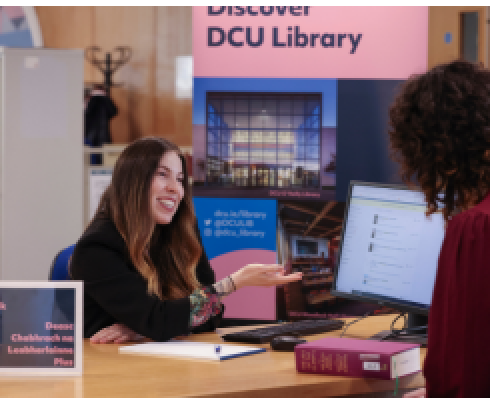 library staff helping student at help desk