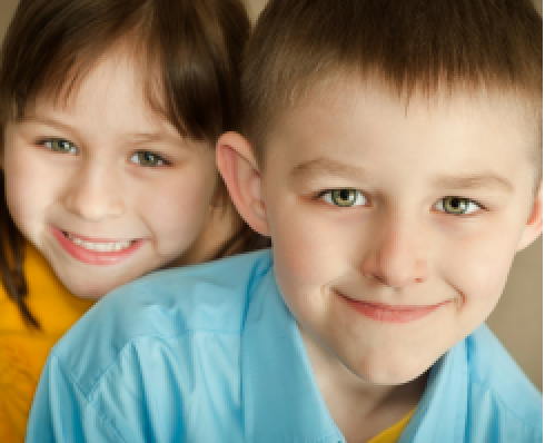Two children, a girl and a boy, up close to the camera