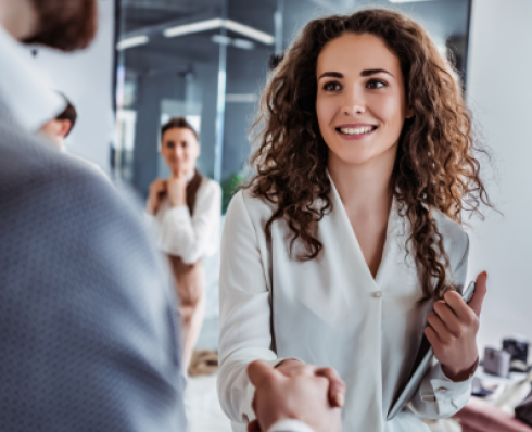 woman shaking someone's hand in a greeting