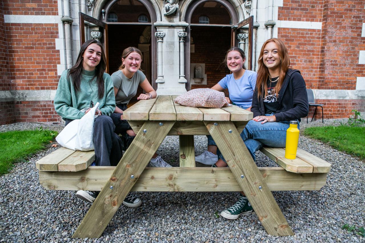 Students sitting around picnic table at DCU St Patrick's Campus