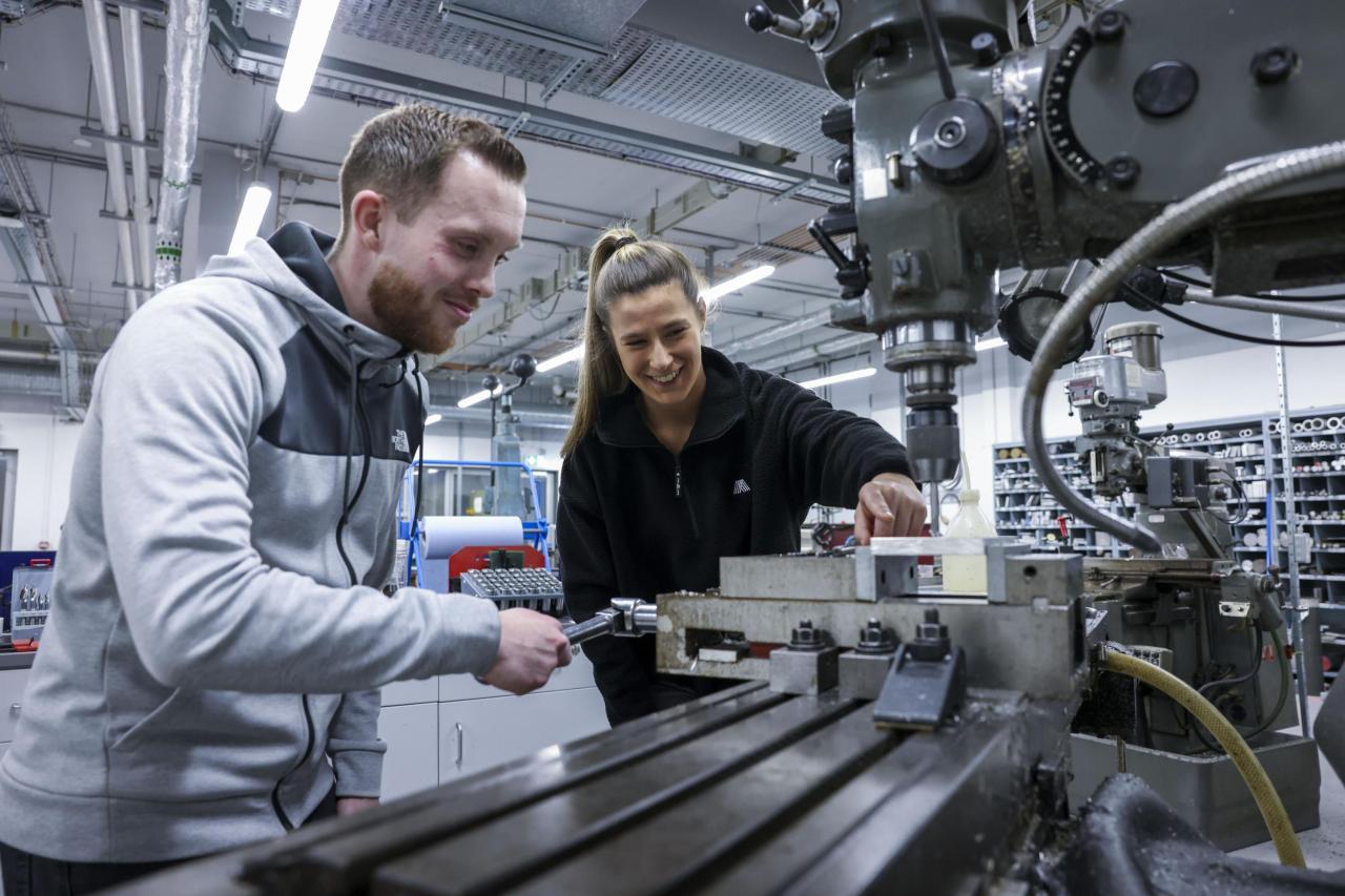 Students working on a machine in a workshop